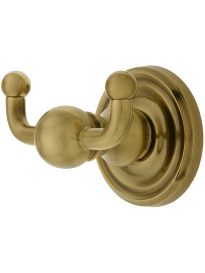 Solid Brass Double Hook with Classic Rosette in Antique Brass.
